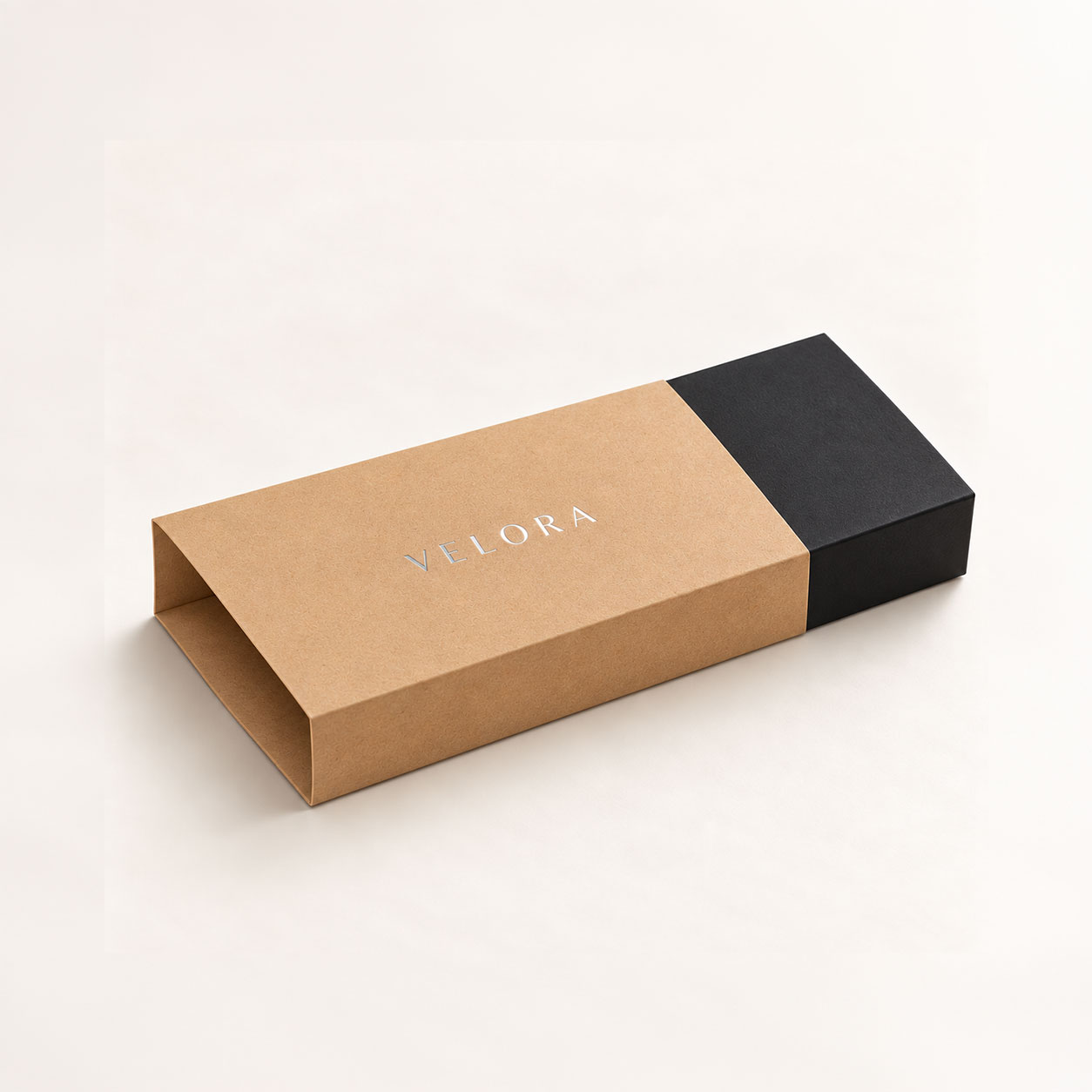 Kraft packaging sleeve with a silver foil logo around a black gift box